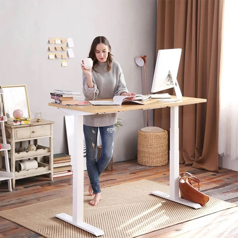 A woman using the desk with a coffee in her hand