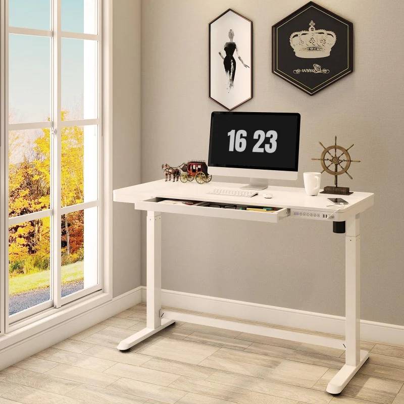 A desk with a Mac on it