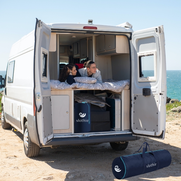 people are using camping mattress in a van